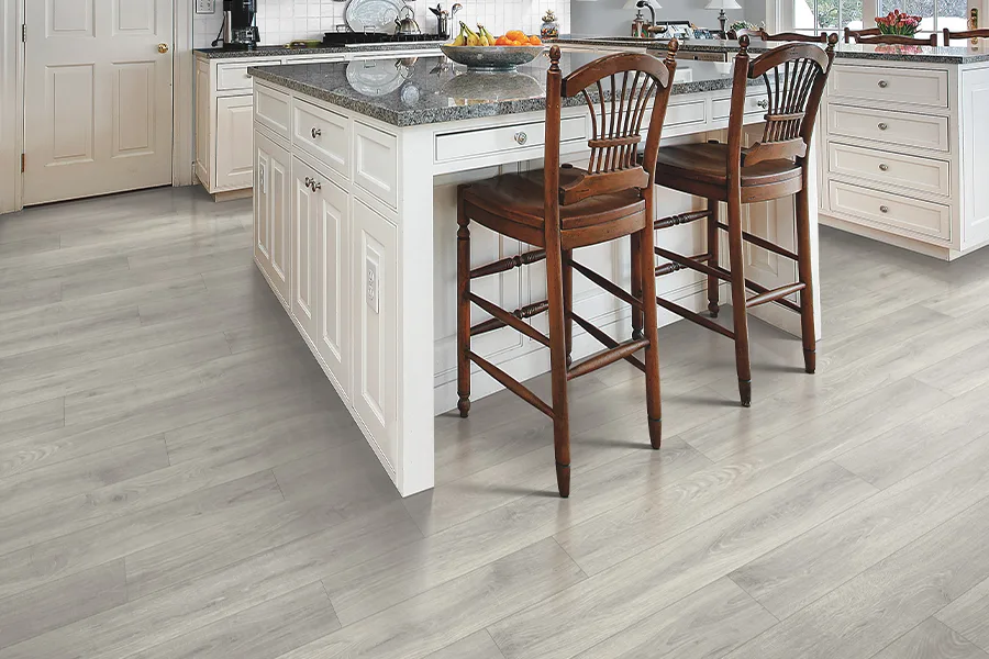Laminate floors in a large kitchen with an island by O'krent in San Antonio Texas